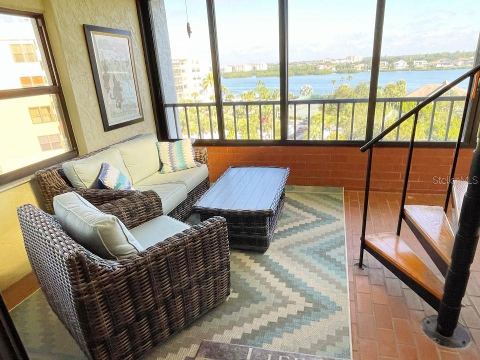 5911 Midnight Pass Road, Unit 601 Sarasota, FL 34242 - Photo 9 of 48 a living room with furniture and a floor to ceiling window