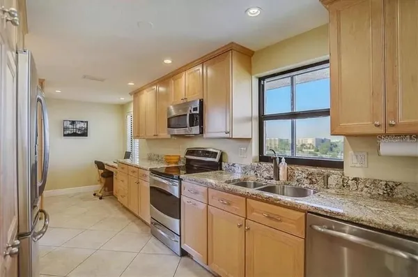 a bathroom with a glass shower door and a sink