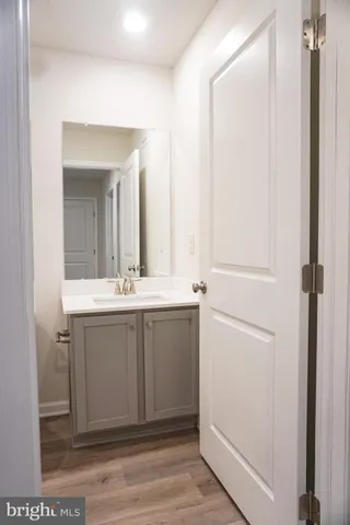 a bathroom with a sink vanity and a mirror