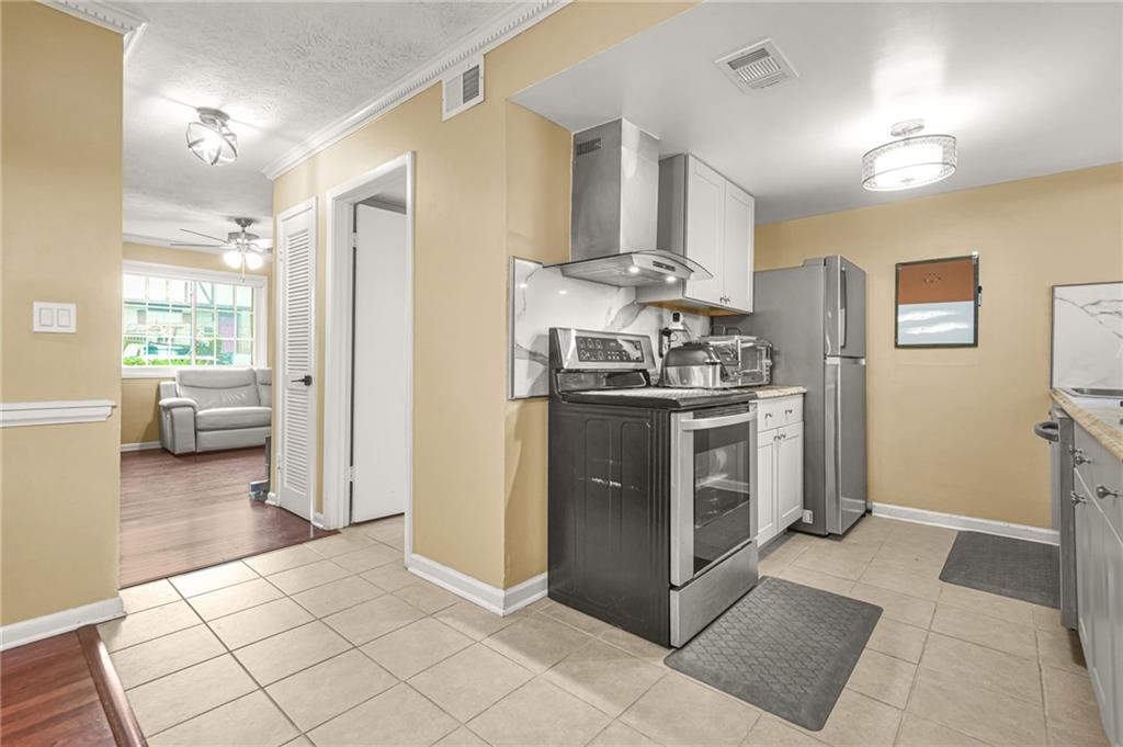 2952 North Dekalb Drive, Unit C Atlanta, GA 30340 - Photo 11 of 27 a kitchen with stainless steel appliances granite countertop a stove a refrigerator and a cabinets