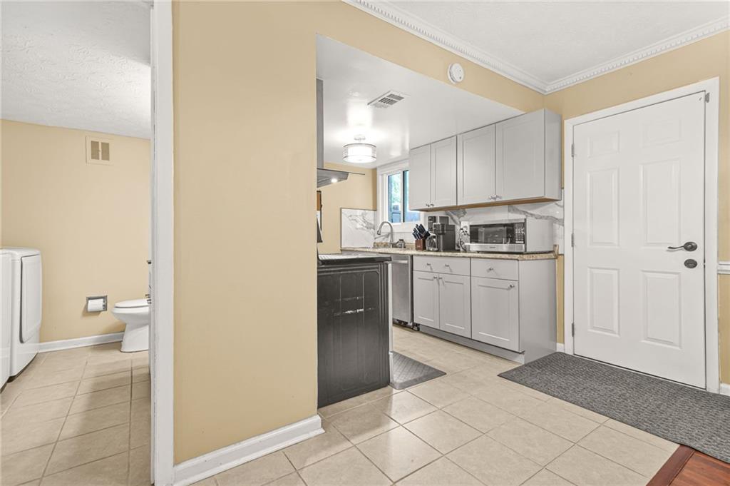 2952 North Dekalb Drive, Unit C Atlanta, GA 30340 - Photo 12 of 27 a kitchen with a sink a stove cabinets and a refrigerator