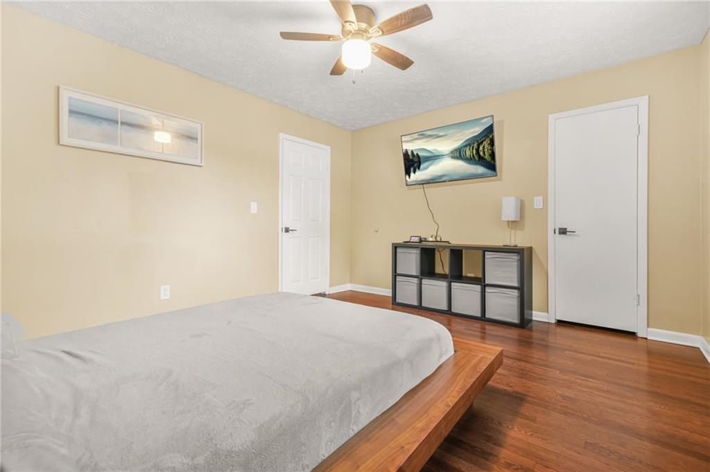 2952 North Dekalb Drive, Unit C Atlanta, GA 30340 - Photo 15 of 27 a bedroom with a bed and a chandelier