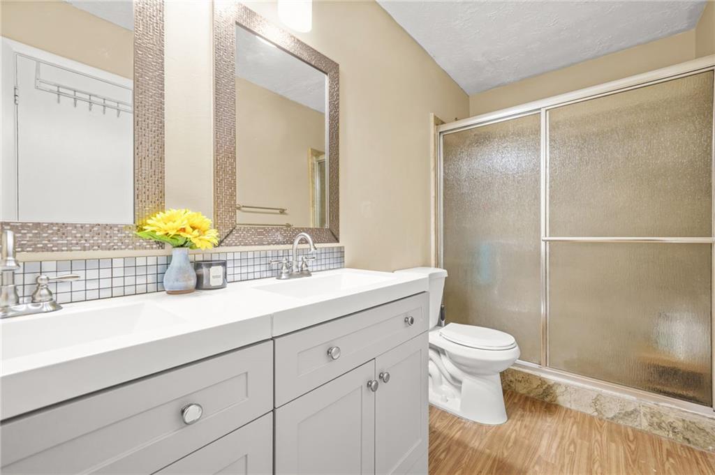 2952 North Dekalb Drive, Unit C Atlanta, GA 30340 - Photo 17 of 27 a bathroom with a granite countertop sink a toilet and a shower