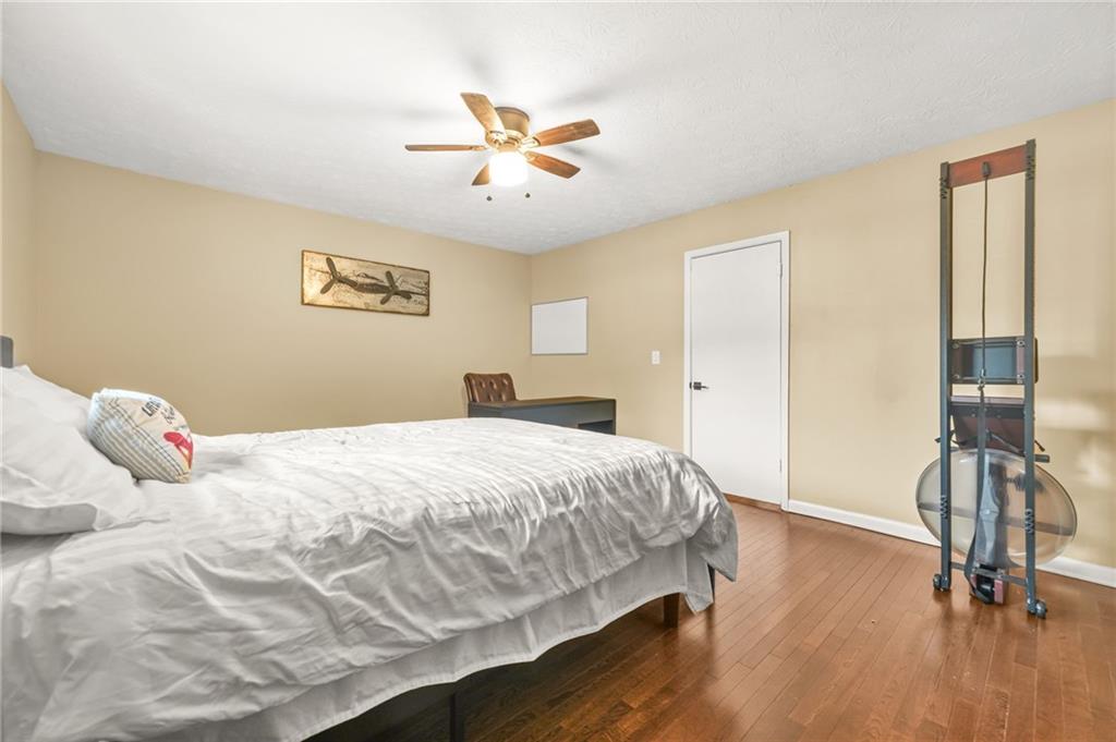 2952 North Dekalb Drive, Unit C Atlanta, GA 30340 - Photo 20 of 27 a bedroom with a bed and wooden floor