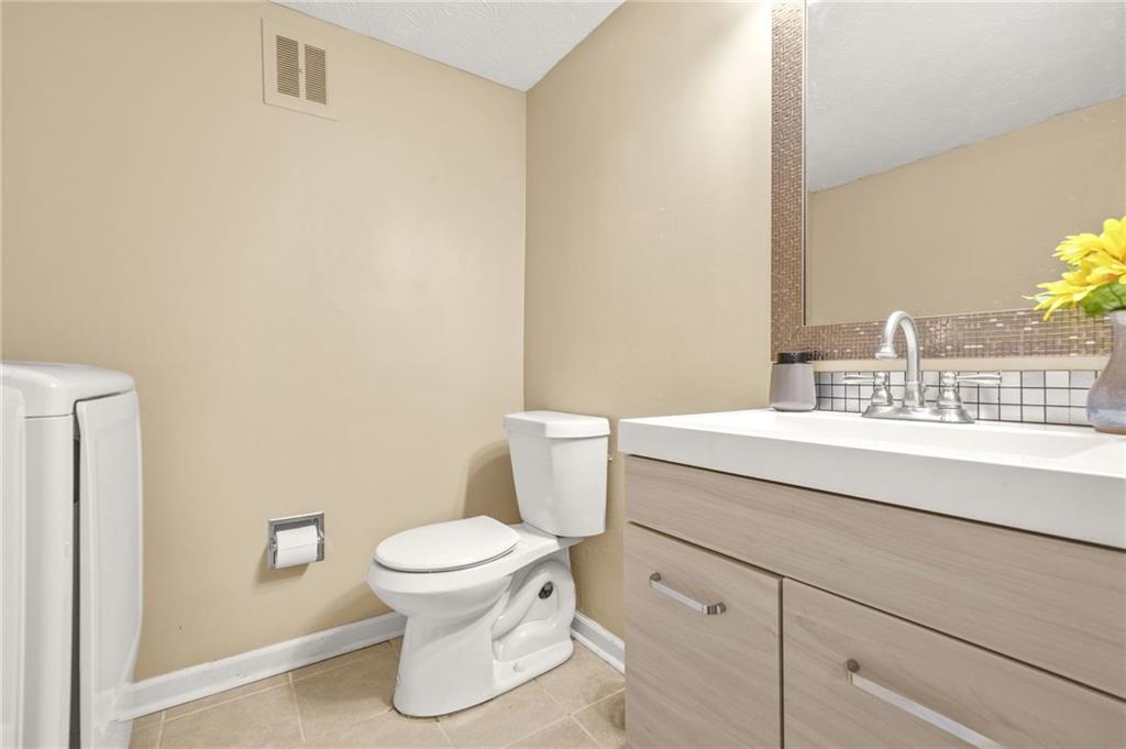 2952 North Dekalb Drive, Unit C Atlanta, GA 30340 - Photo 22 of 27 a bathroom with a sink a toilet and a mirror