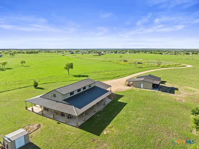 a view of a city with an ocean and a big yard