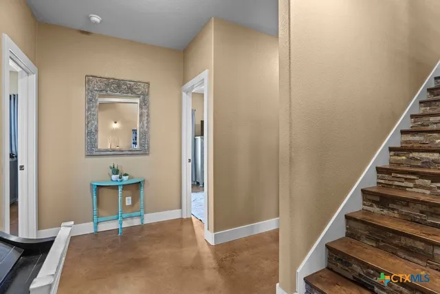 a bedroom with a bed and large windows