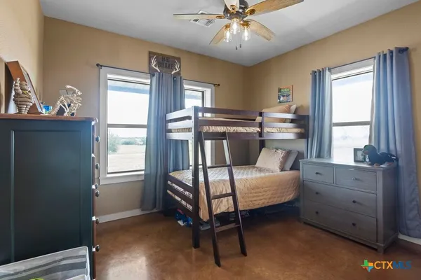 a bathroom with a granite countertop sink toilet and mirror