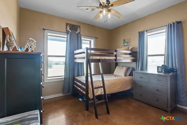 a bathroom with a granite countertop sink toilet and mirror