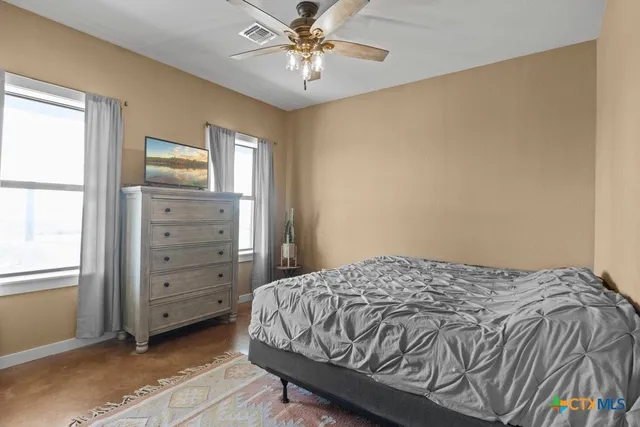 a bedroom with a bed and a window