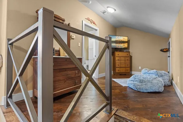 a bedroom with bed and a chandelier