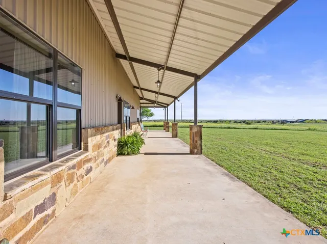 a view of chairs and table in the balcony