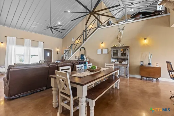 a view of a dining room with furniture and a table
