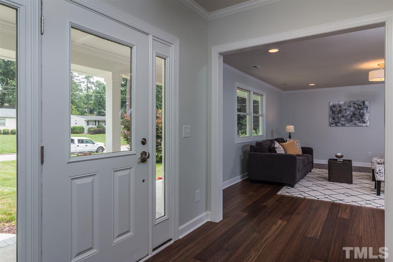 3411 Leonard Street Raleigh, NC 27607 - Photo 3 of 25 a bedroom with a bed and wooden floor