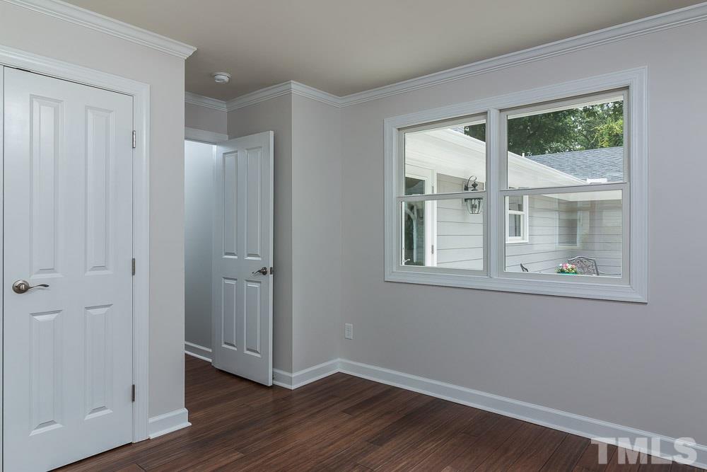 3411 Leonard Street Raleigh, NC 27607 - Photo 21 of 25 a view of an empty room with wooden floor and a window