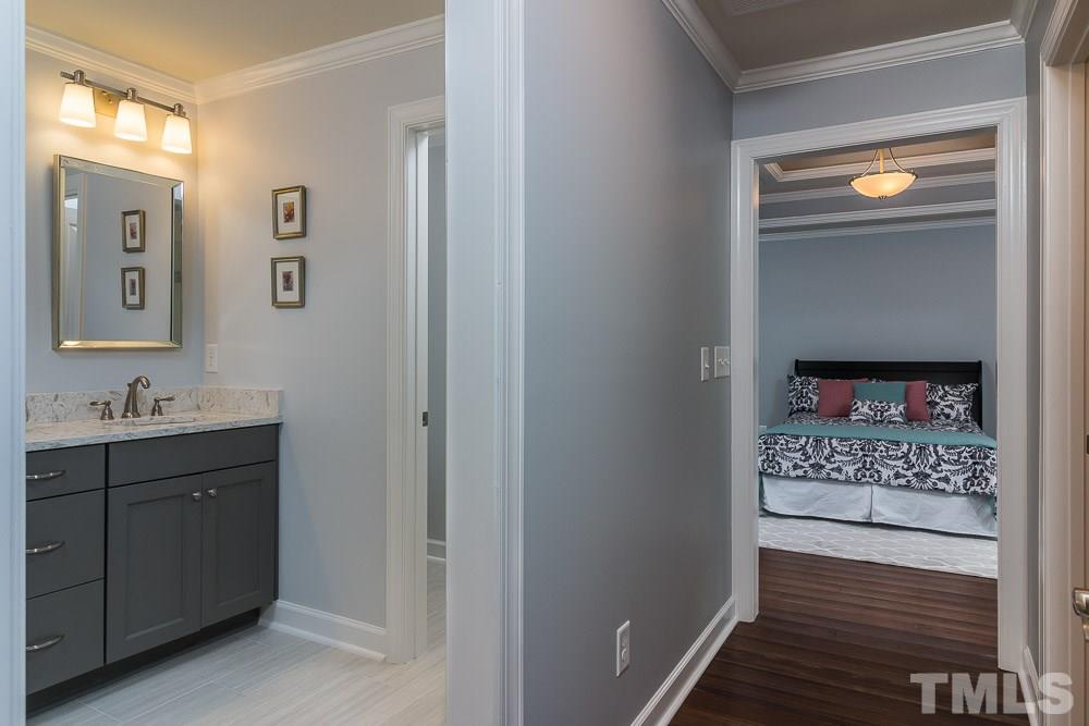 3411 Leonard Street Raleigh, NC 27607 - Photo 9 of 25 a view of hallway with a sink and a mirror