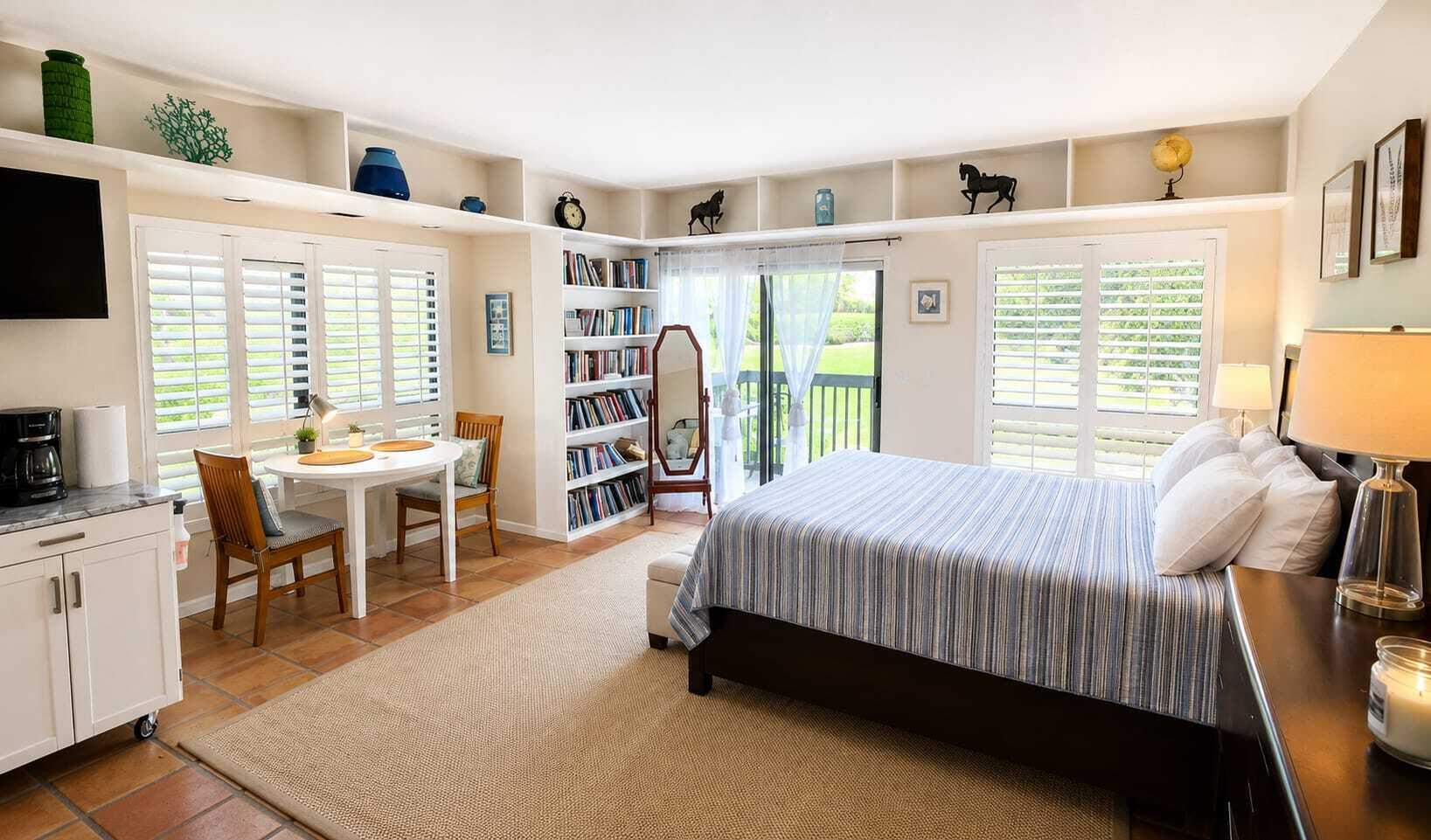 13334 Polo Club Road, Unit 216 Wellington, FL 33414 - Photo 3 of 9 a spacious bedroom with a bed and a table in it