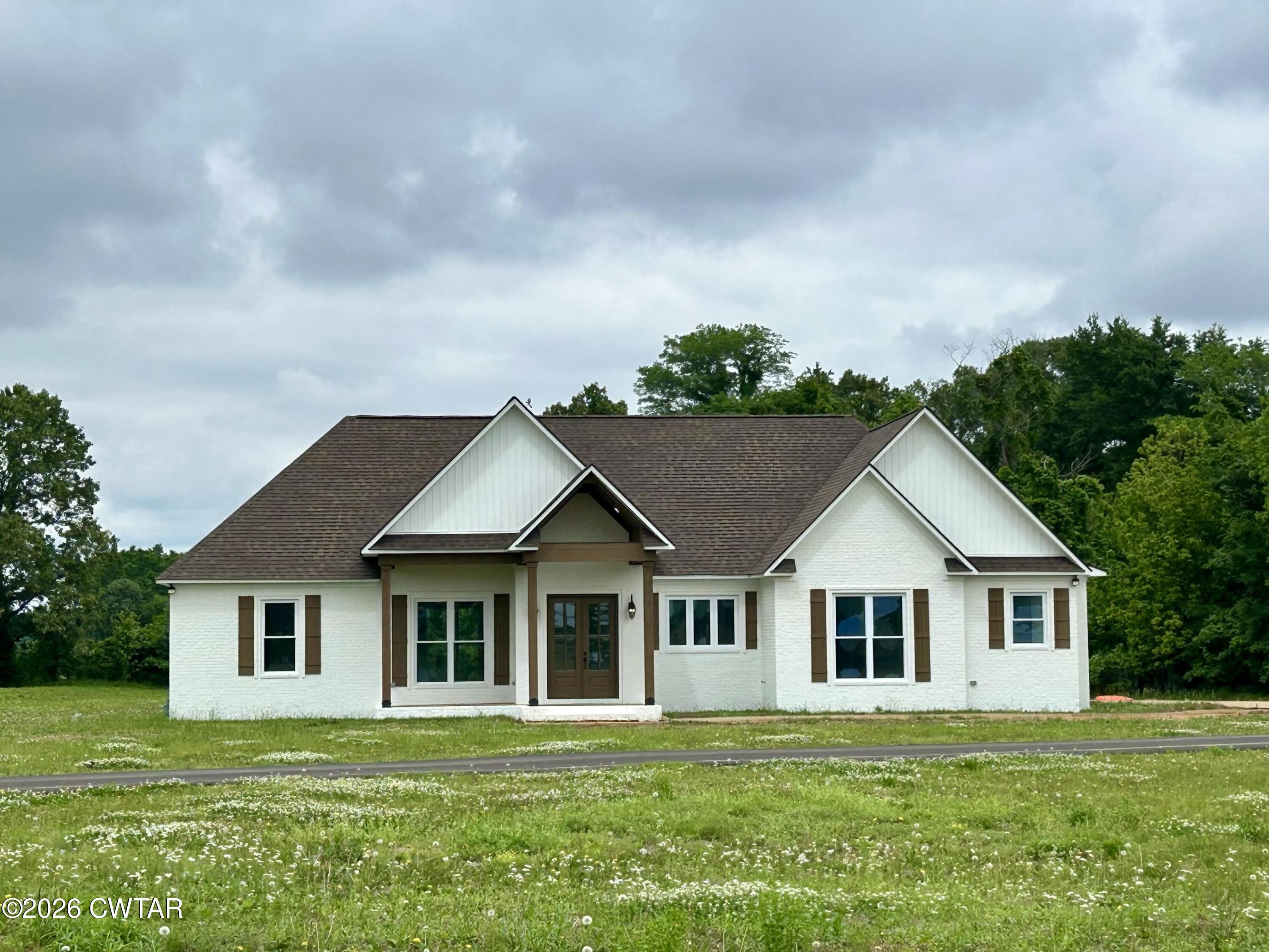 132 Esquire Peek Road Humboldt, TN 38343 - Photo 1 of 1 a front view of a house with a yard