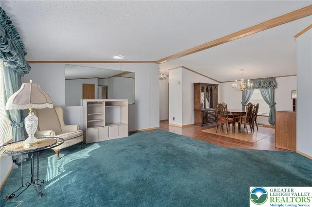 a dining room with furniture a chandelier and wooden floor