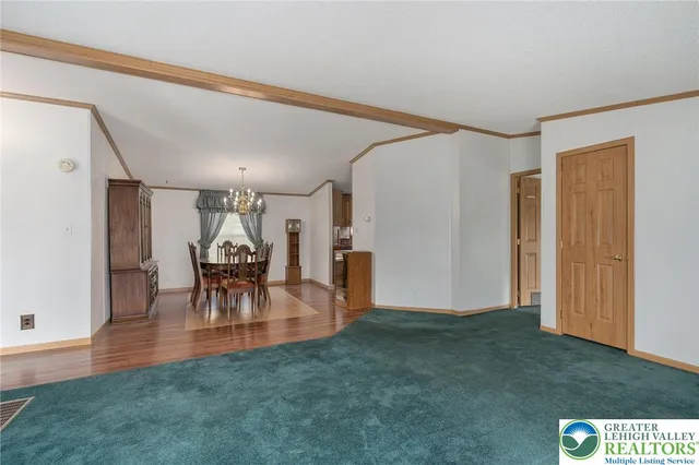 a dining room with furniture and chandelier