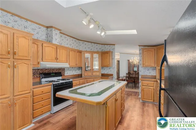 a view of an empty room with a window and fireplace