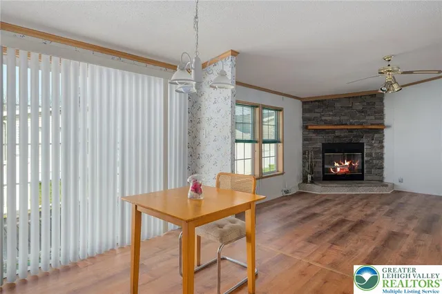 a view of a livingroom with a fireplace and wooden floor