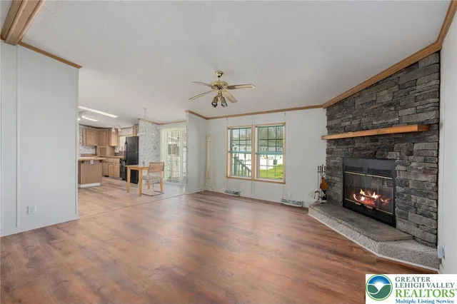 a view of empty room with wooden floor and windows