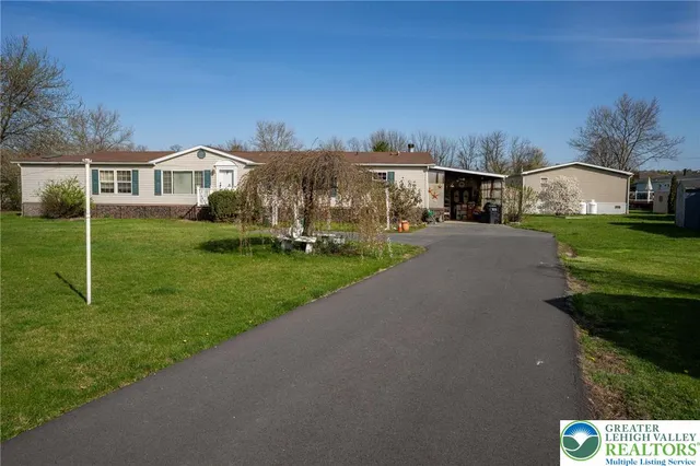 a view of a house with backyard and porch