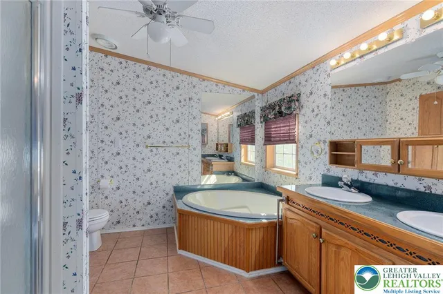 a view of a livingroom with a ceiling fan and window
