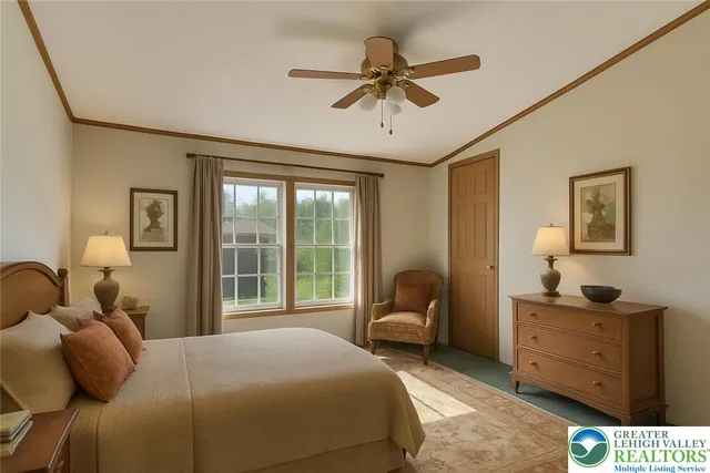 a bedroom with a bed and a dresser next to a window