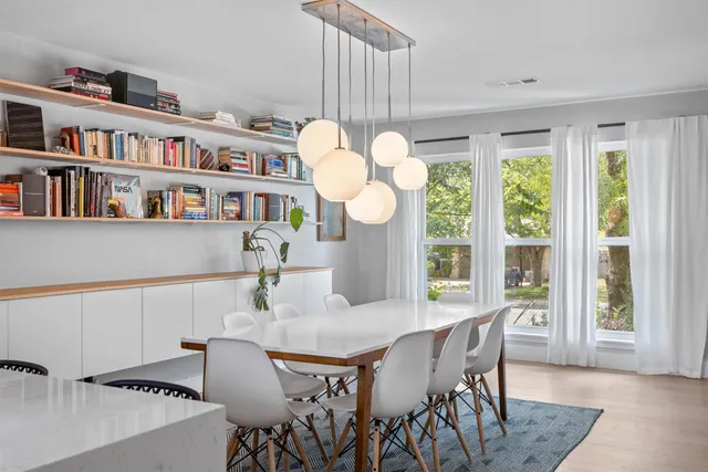 a dining room with furniture and a book shelf