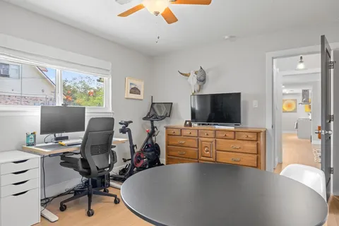 a view of a workspace with furniture and a window