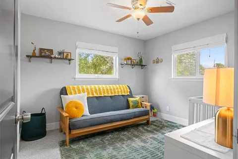 a bedroom with furniture and a book shelf