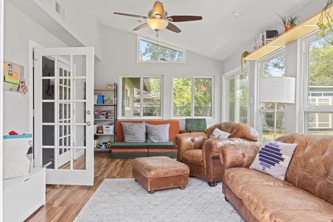 a living room filled with furniture and a floor to ceiling window