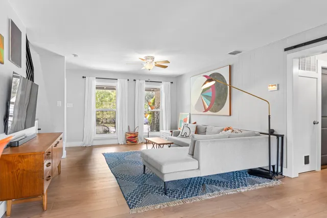 a living room with furniture and a large window