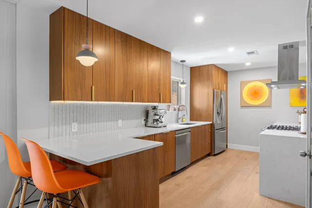 a kitchen with a sink cabinets and wooden floor