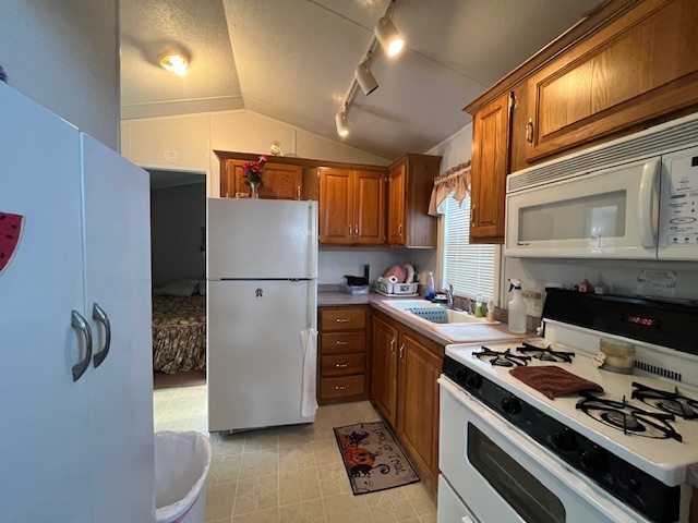 2795 East 28th Road Marseilles, IL 61341 - Photo 10 of 57 a kitchen with a refrigerator a stove top oven a sink and cabinets