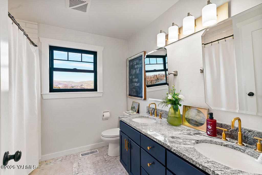 367 Baker Road Selah, WA 98942 - Photo 28 of 55 a bathroom with a granite countertop sink mirror vanity and toilet
