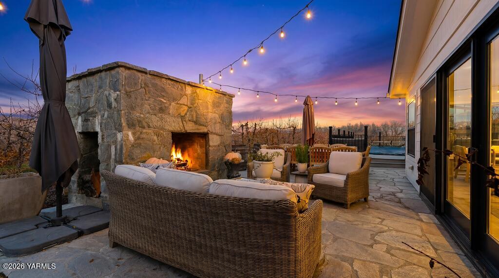 367 Baker Road Selah, WA 98942 - Photo 37 of 55 a living room with furniture a fireplace and a floor to ceiling window