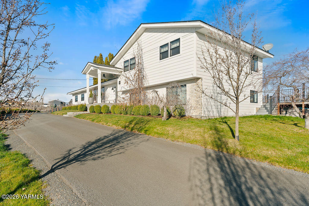 367 Baker Road Selah, WA 98942 - Photo 40 of 55 a view of a white house with a large trees with wooden fence