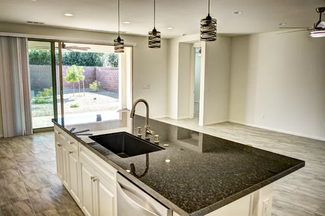 a kitchen with stainless steel appliances a refrigerator and a stove top oven