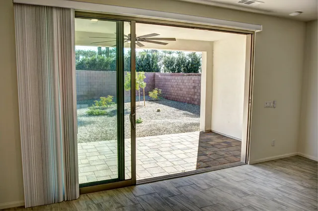 a park with lots of green space and fountain in the back