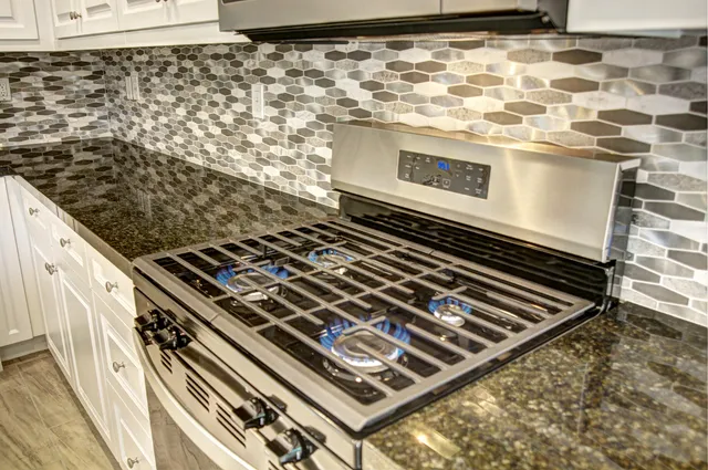 a close view of a stove a oven and a window