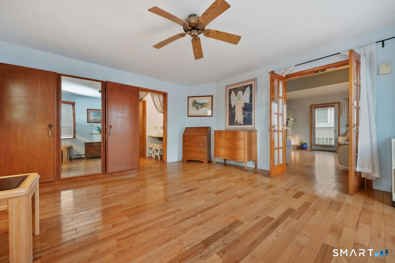 6 Lighthouse Point Fairfield, CT 06824 - Photo 11 of 40 a view of a livingroom with wooden floor and a ceiling fan