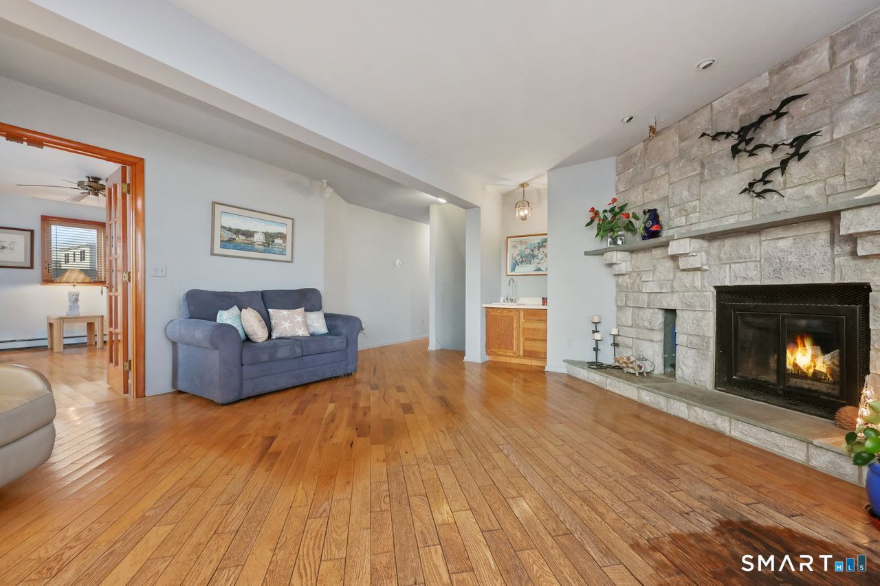 6 Lighthouse Point Fairfield, CT 06824 - Photo 15 of 40 a living room with furniture and a fireplace