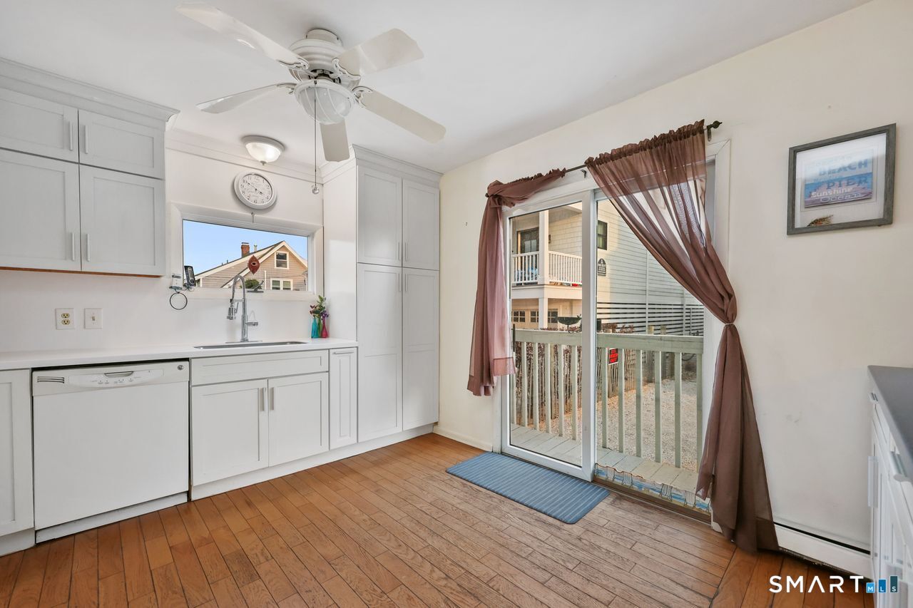 6 Lighthouse Point Fairfield, CT 06824 - Photo 19 of 40 a kitchen with granite countertop white cabinets and white appliances