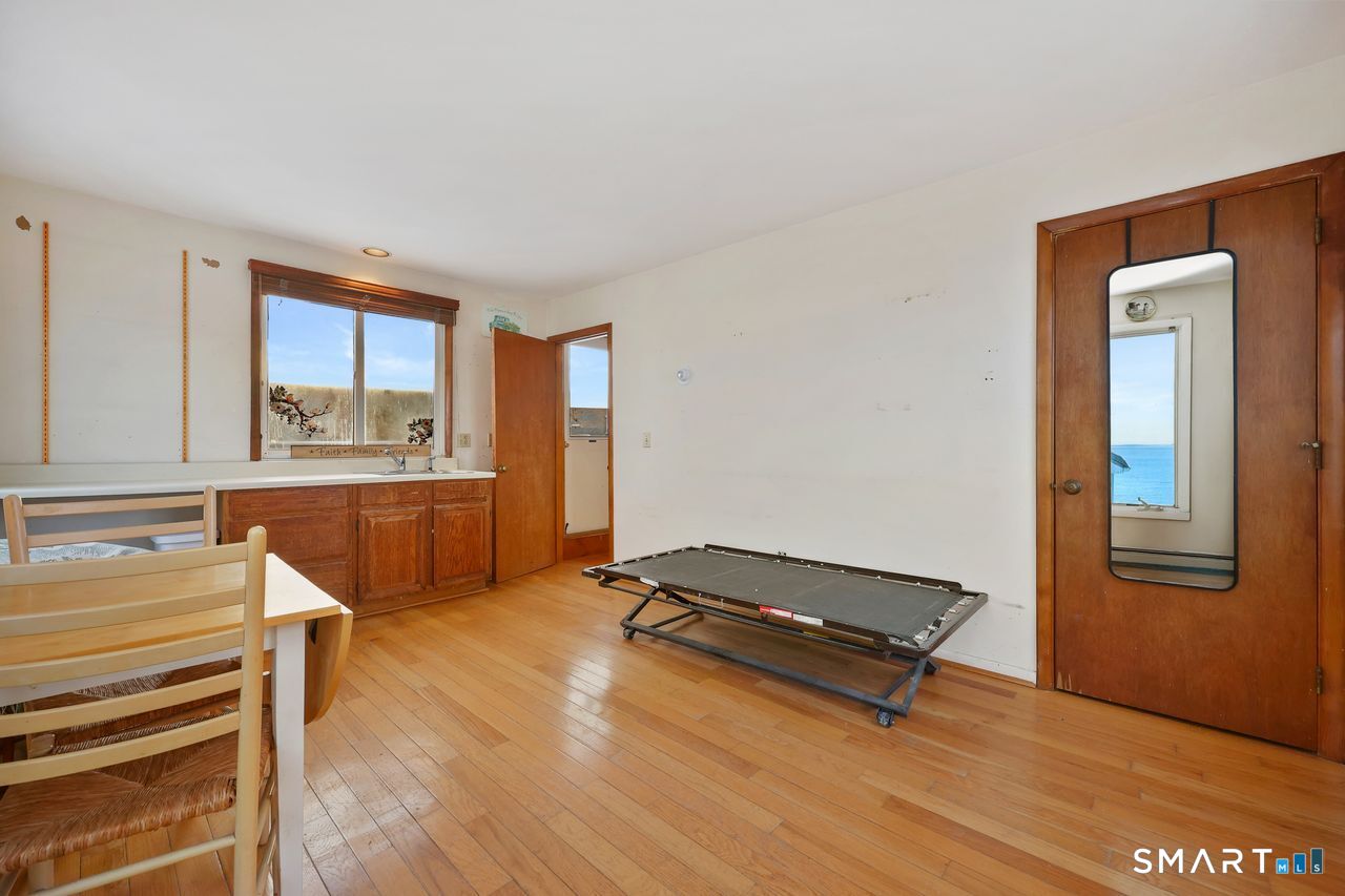 6 Lighthouse Point Fairfield, CT 06824 - Photo 22 of 40 a living room with a dresser and a window
