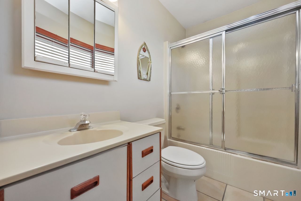 6 Lighthouse Point Fairfield, CT 06824 - Photo 24 of 40 a bathroom with a sink a toilet and shower