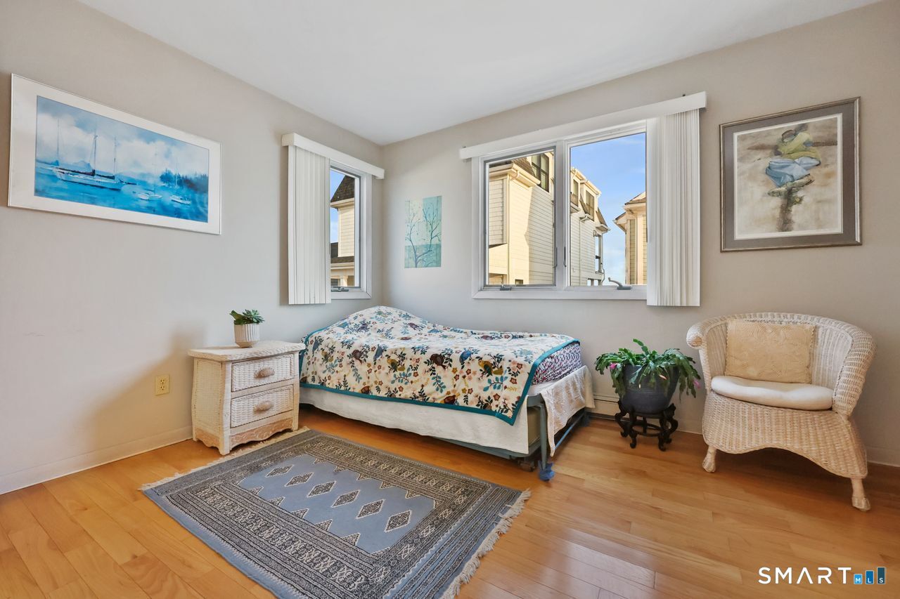 6 Lighthouse Point Fairfield, CT 06824 - Photo 26 of 40 a bedroom with a bed and a couch