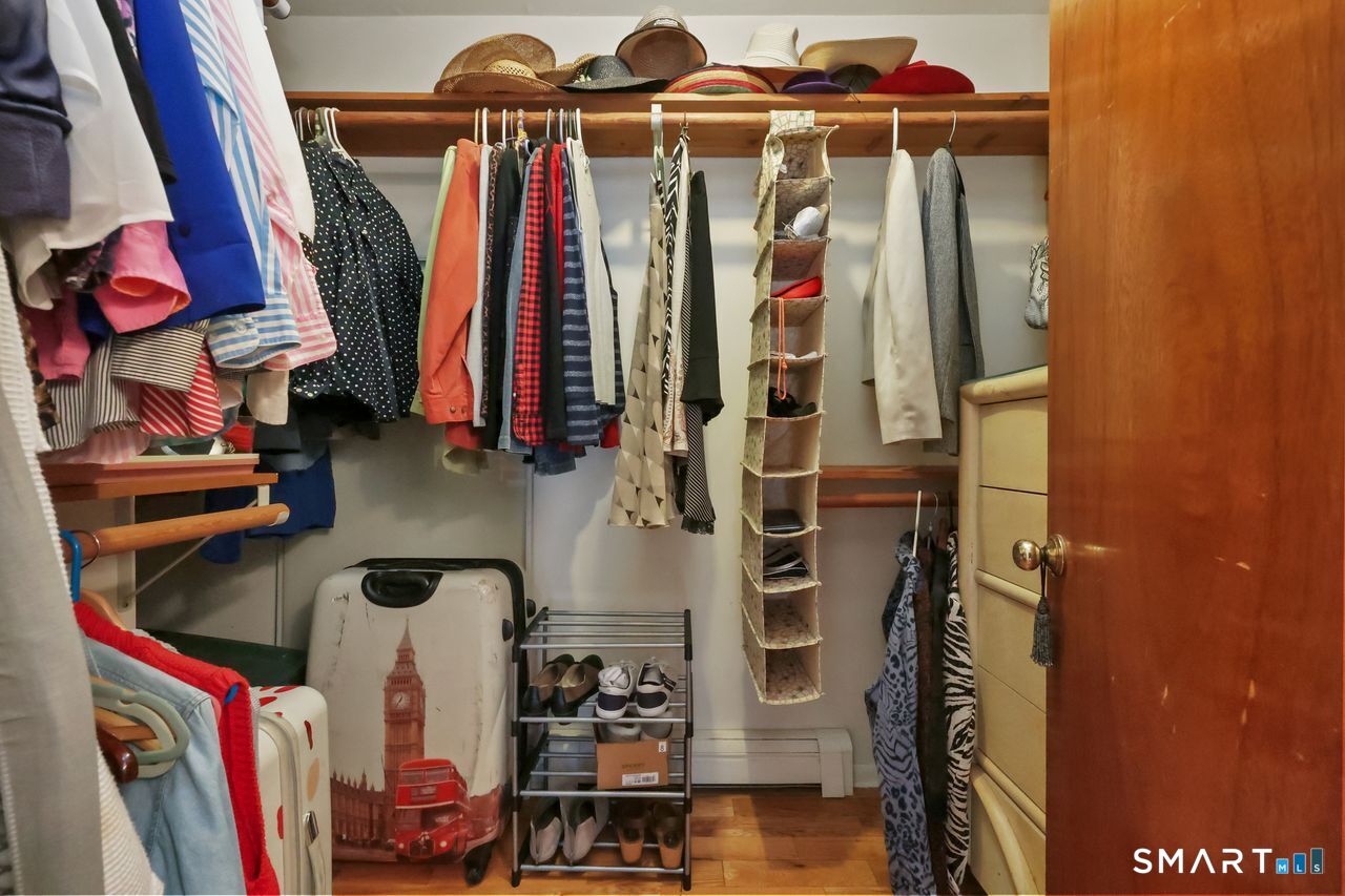 6 Lighthouse Point Fairfield, CT 06824 - Photo 29 of 40 a view of walk in closet with clothes and shoes